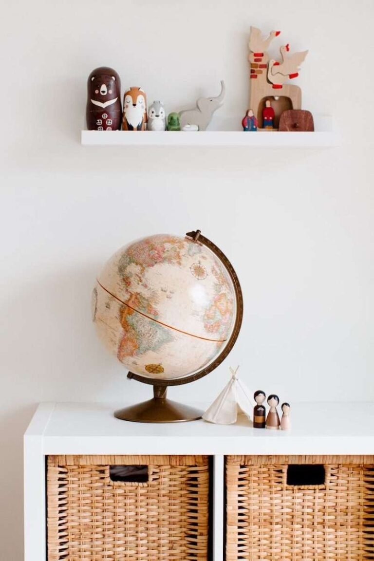 retro toys and globe on cabinet in nursery room