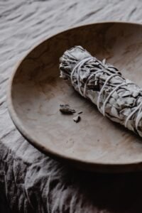 ceramic plate with white sage smudge stick